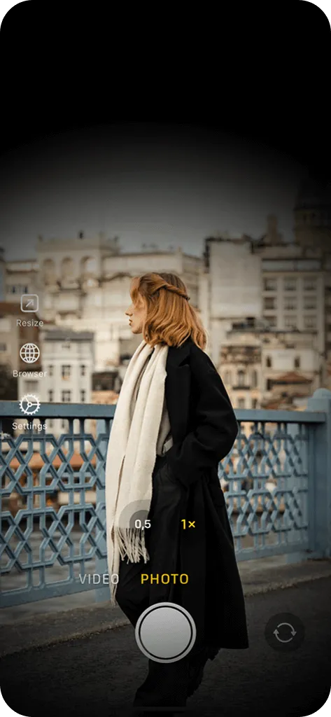 The discreet recording mode in a spy camera app, featuring a dimmed black screen while capturing a photo of a woman wearing a jacket.